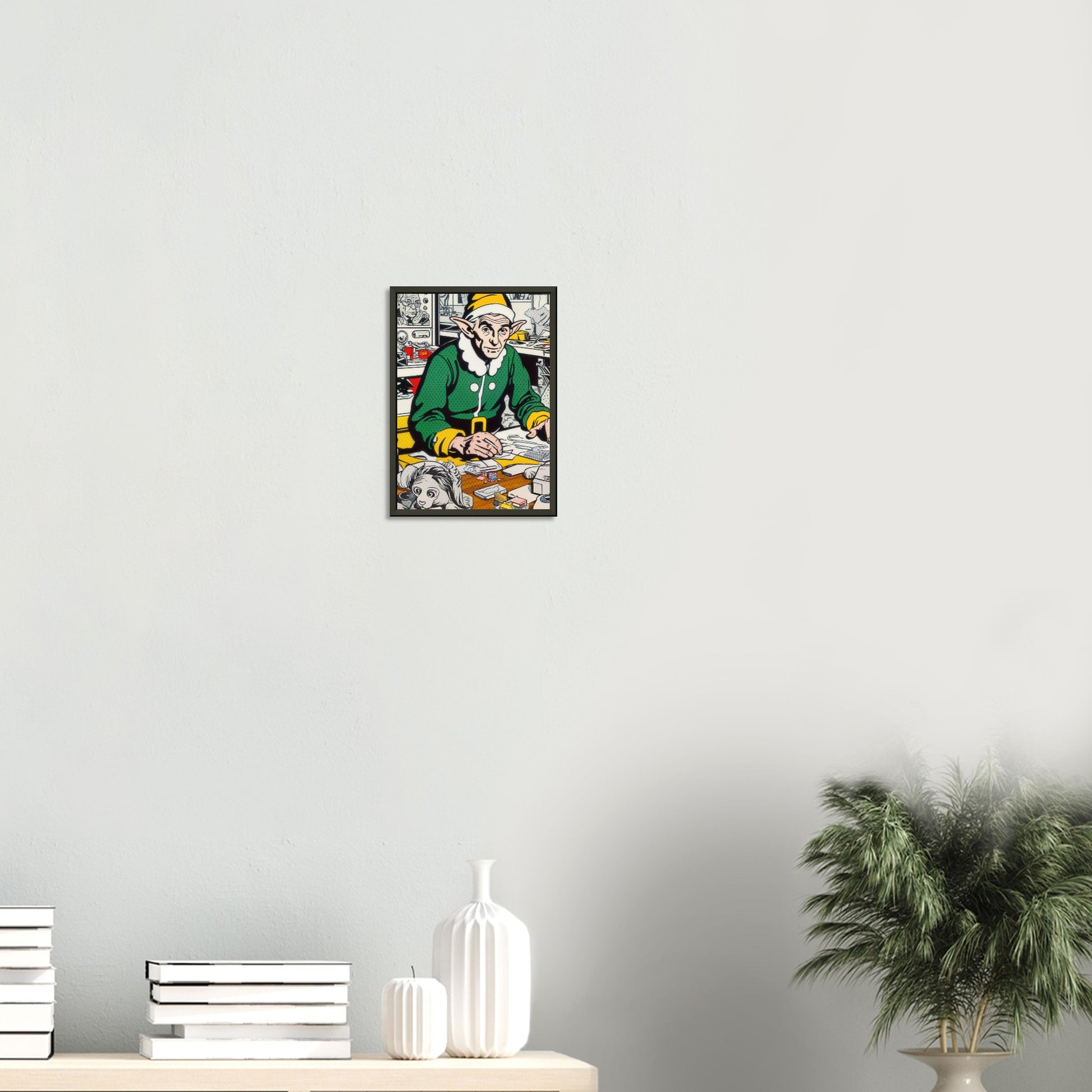 The Tired Elf – poster in aluminium lijst boven een wit dressoir met planten